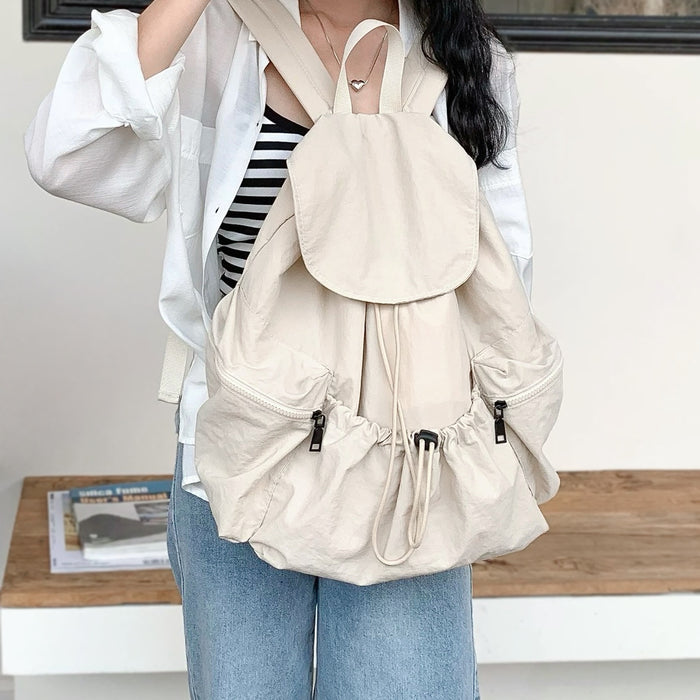 Model wearing the beige backpack; ergonomic straps designed for comfortable all-day wear.