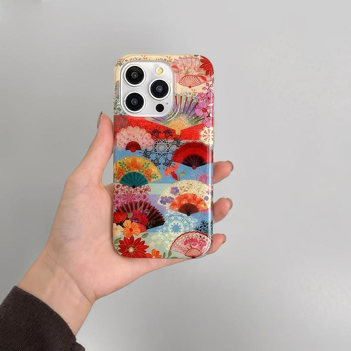 Colorful Japanese fan and floral pattern on an acrylic iPhone case. Vibrant botanical art for trendy accessories.