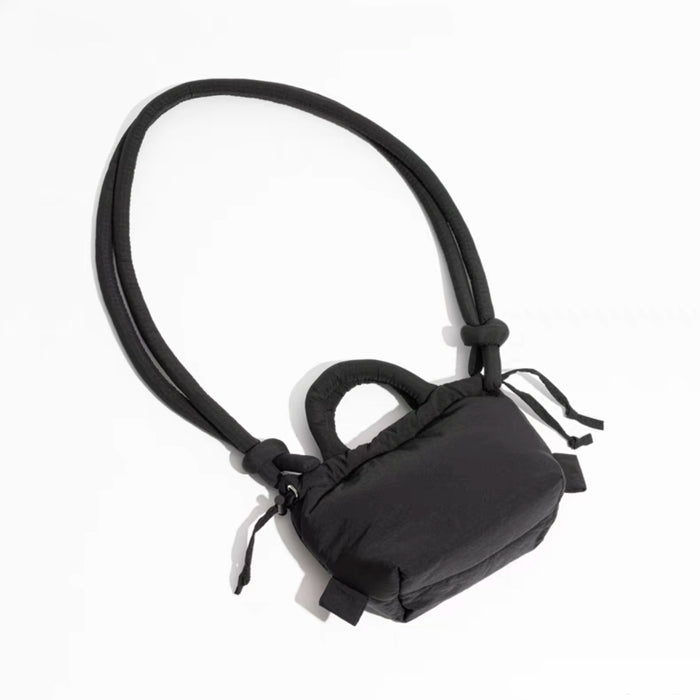 Top view of black multi use bag, showing the detail of the knot and padded fabric.
