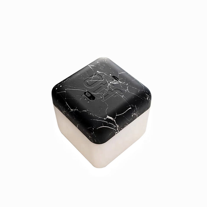 Front view of dark marble Flipping Cubic Timer Lamp, with a black marble-patterned top and glowing white base.