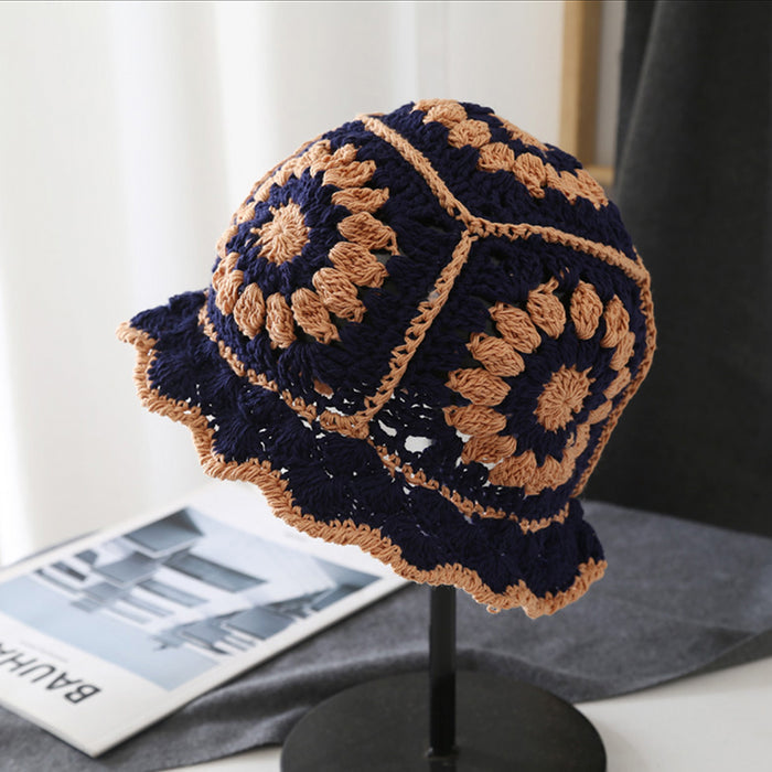 Navy blue and tan floral crochet bucket hat made of breathable polyester-cotton for all-day comfort.