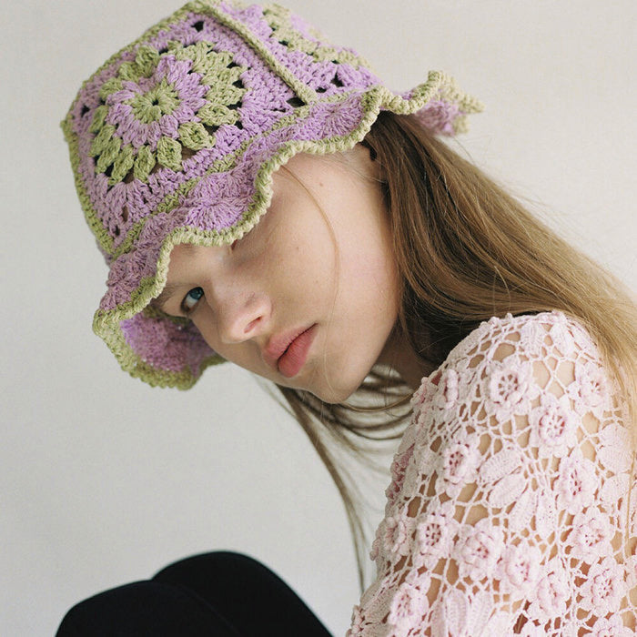 Model wearing purple Floral Crochet Hat, featuring intricate handmade floral patterns and a soft fit.