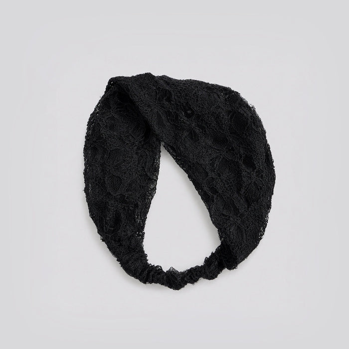 Studio view of the black floral lace headband looped to show its flexible stretch construction and floral pattern.