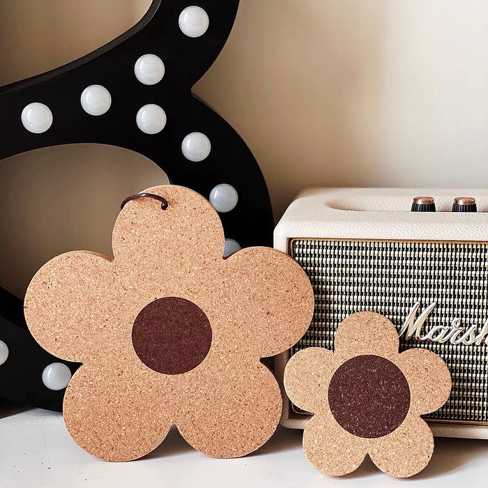 Front view of Two flower-shaped cork coasters/hot pads, one large and one small.