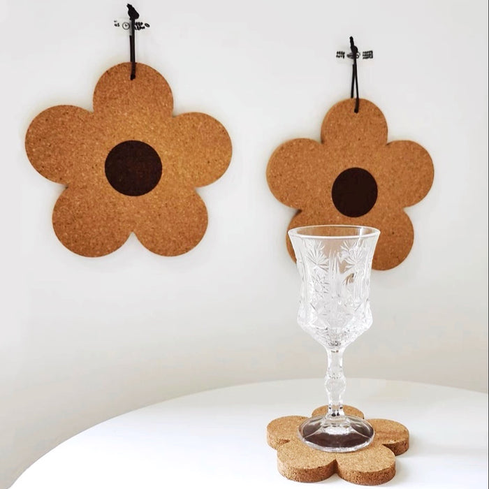 Close-up of Flower Cork Coaster with a cup on it and two flower coasters hanging on the wall.