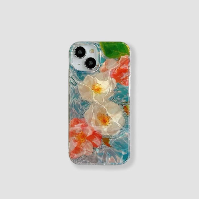 Clear silicone iPhone case with white and pink flowers. Dreamy blue water design for a refreshing aesthetic.