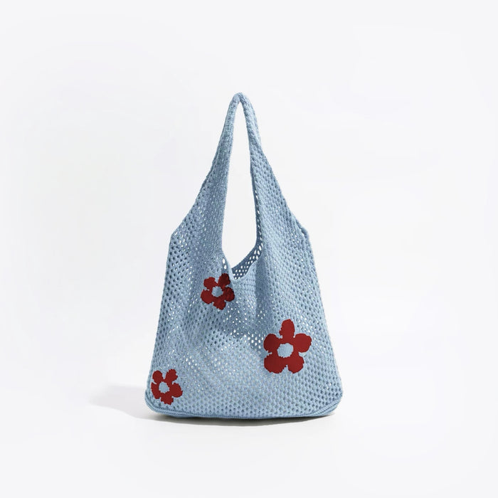 Angled view of Flowers Crochet Shoulder Bag in blue, great for everyday carry and travel.