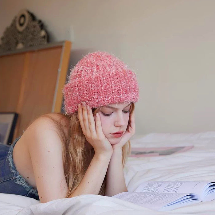Model wearing pink Fluffy Knitted Thick Beanie. Soft feminine color combined with high-performance winter warmth.