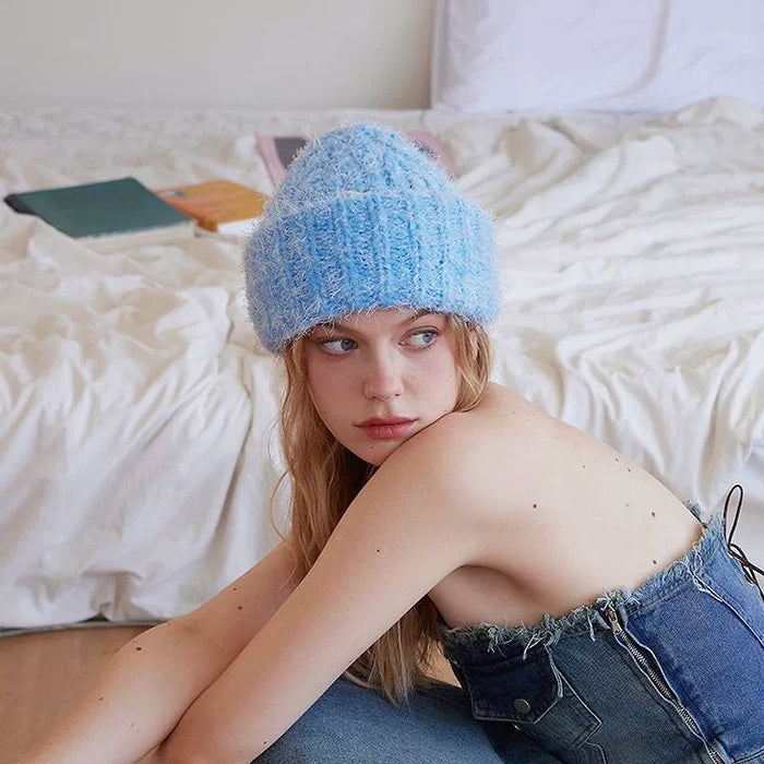 Model wearing blue Fluffy Knitted Thick Beanie. Vibrant winter accessory offering maximum comfort and insulation.