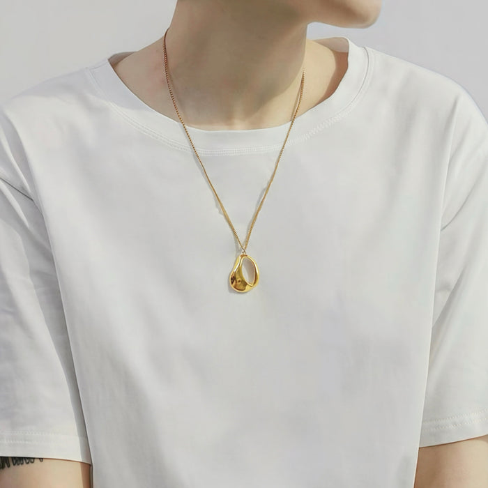 Model styling a Fluid Shapede Pendant Necklace in Gold, ideal for date nights.