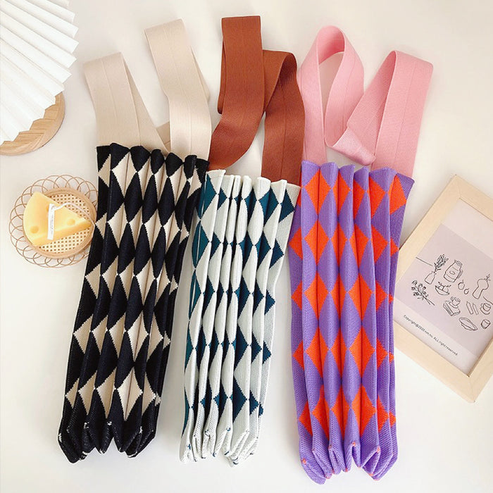 Three argyle knitted bags rolled up to show compact storage and stretchable material.