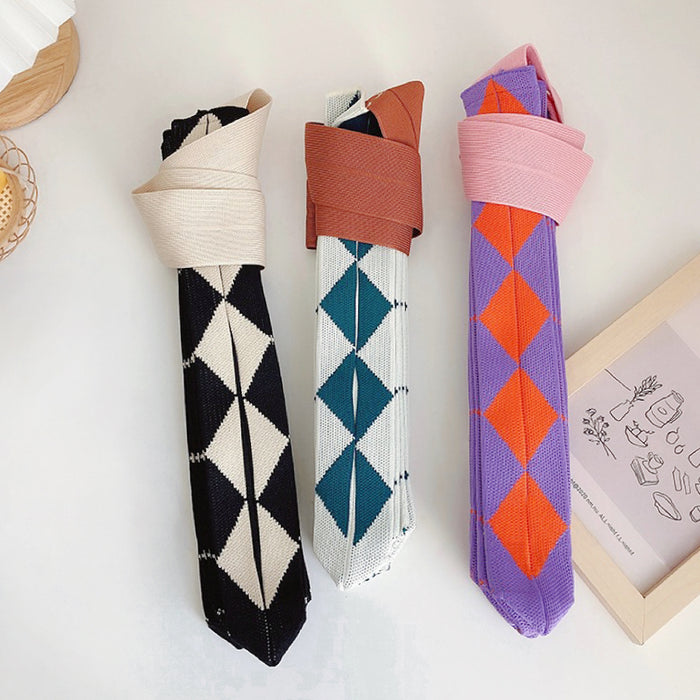 Three argyle knitted bags rolled up to show compact storage and stretchable material.