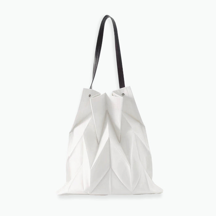 Front view of white pleated shopper bag; sleek geometric texture ideal for pairing with summer dresses and light outfits.