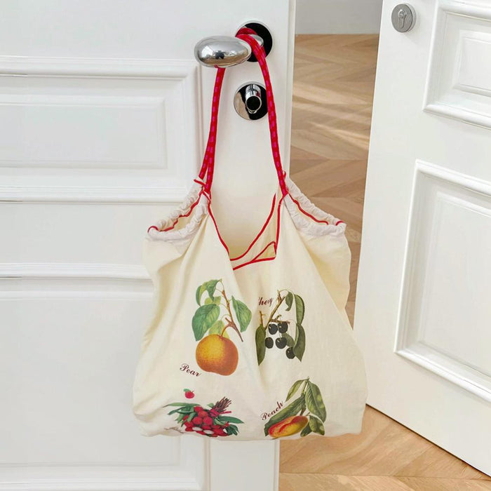 Front view of Polyester Fruit Delight Tote Bag with colorful fruit illustrations and red grab straps.