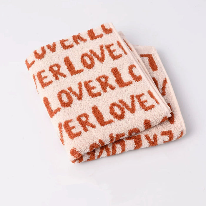 Close-up of Folded face towel with Lovers text on clean background.