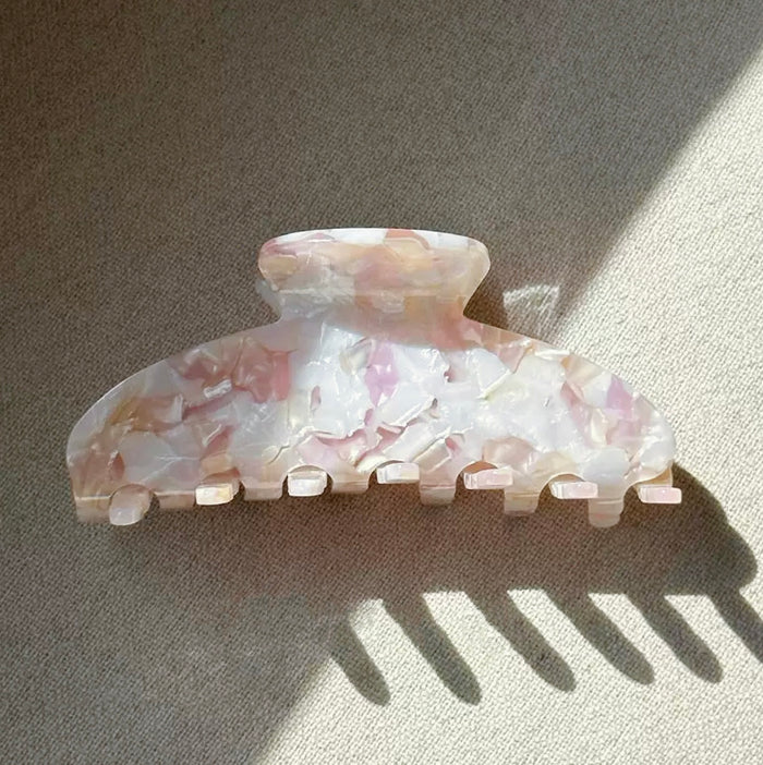 Folded view of Gentle Curve hair claw in rose shell , ideal for quick updos and ponytails.