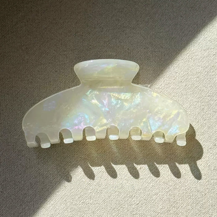 Angled view of Gentle Curve Hair Claw in white moonlight, great for everyday styling and gifting.