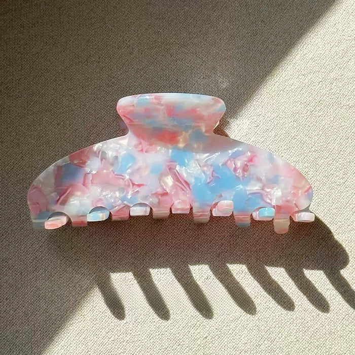 Close-up of Gentle Curve Claw hair claw clip in colorful style, ideal for quick updos.