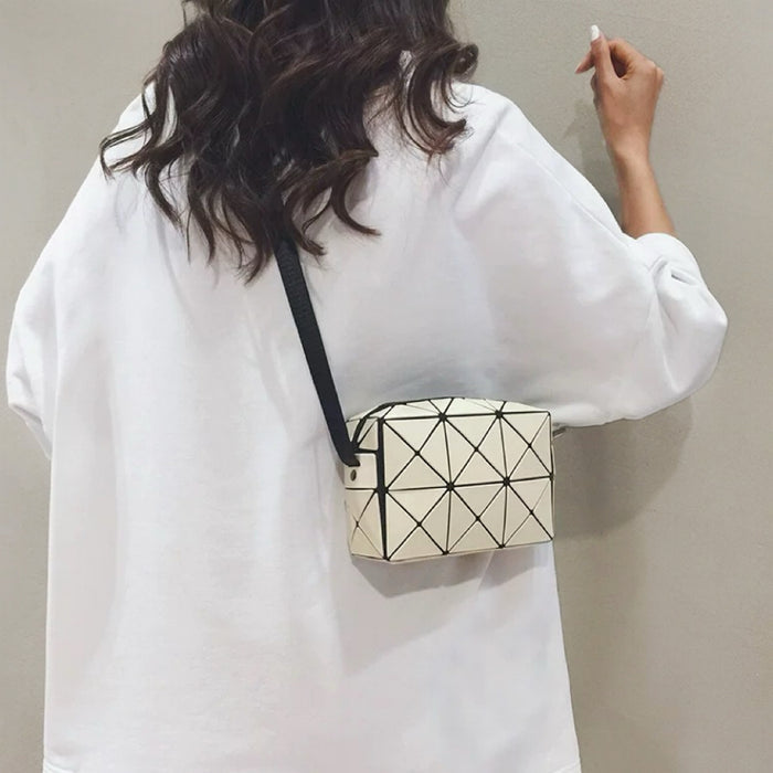 Model carrying a beige geometric crossbody bag as crossbody, easy for commuting and weekends.