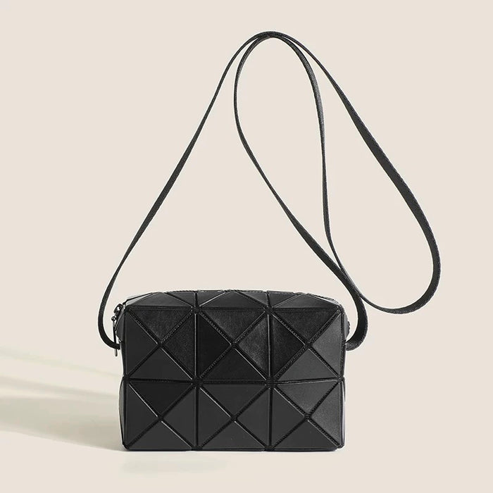Close-up of Black GeoChic PU leather crossbody bag with geometric quilted design and adjustable strap.