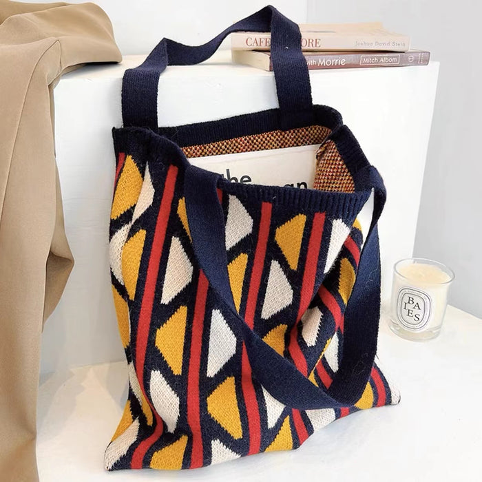 Angled view of Geometric contrast color knitted tote bag in yellow, red and blue.