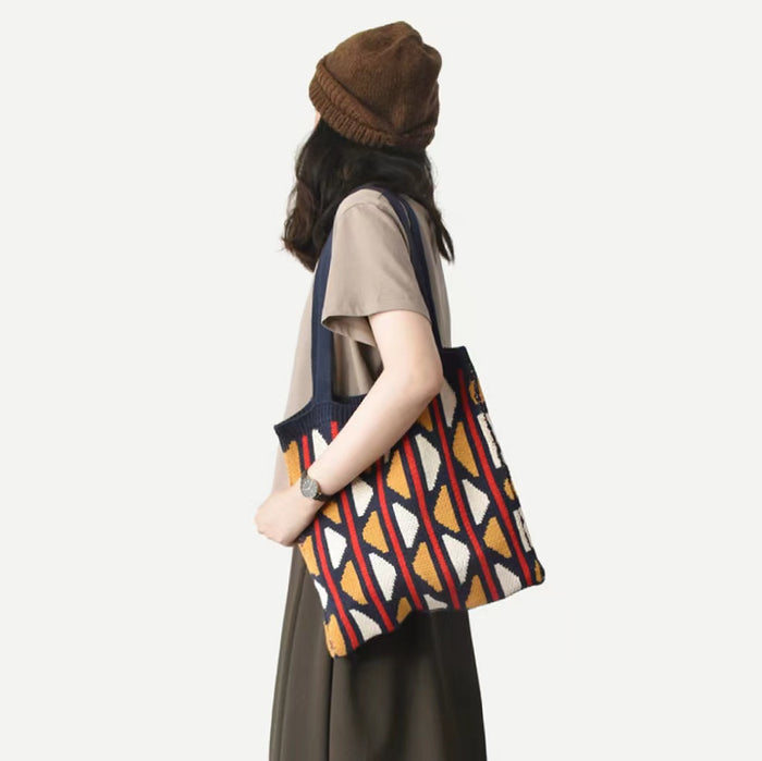 Model carrying a yellow blue geometric tote bag on shoulder, ideal for city walks and gifting.
