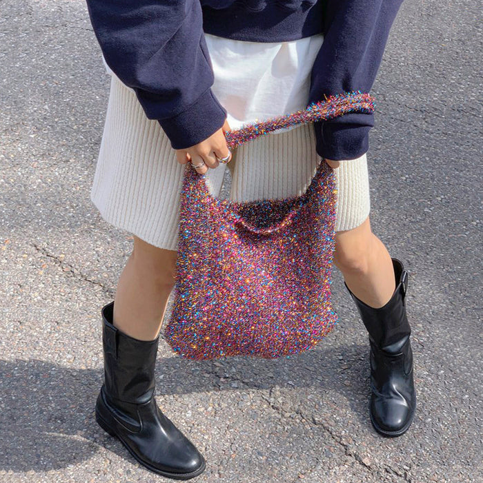 Purple glitter crochet bag with a cool slouchy fit, perfect for festival outfits.