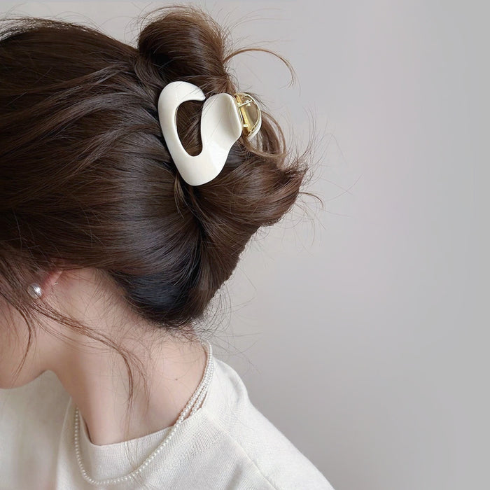 Model wearing a Glossy Cloud Hair Claw in pure white, ideal for quick updos and ponytails.