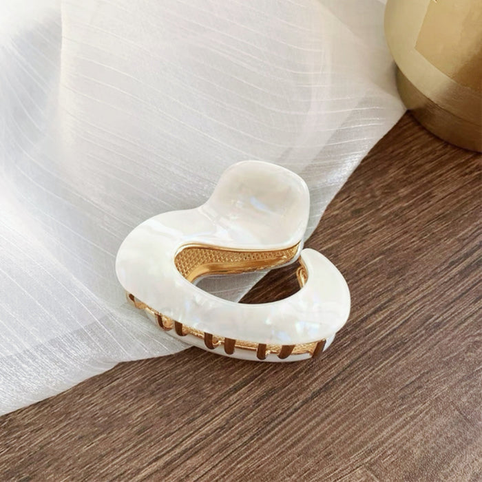 Flat lay of Glossy Cloud Hair Claw in white luster, great for everyday styling and gifting.