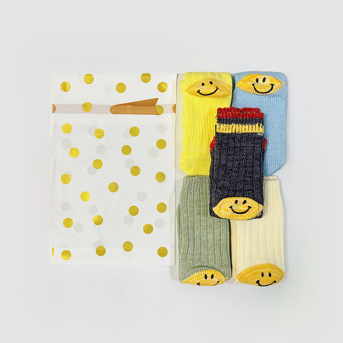 Flat lay of Gold Dot Gift Bag in large size with 5 pairs of socks, showing the size comparation.