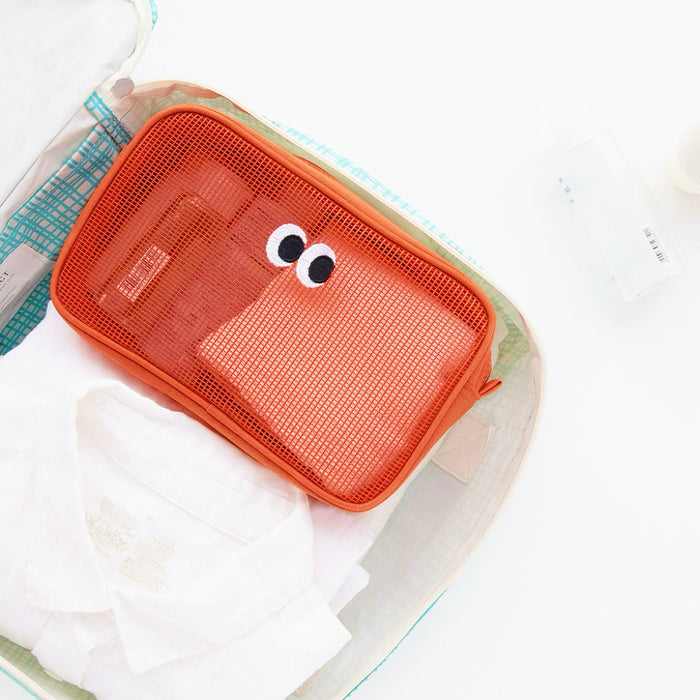 Orange Googly Eyes mesh zip bag in suitcase; see-through organizer for packing toiletries and small items.