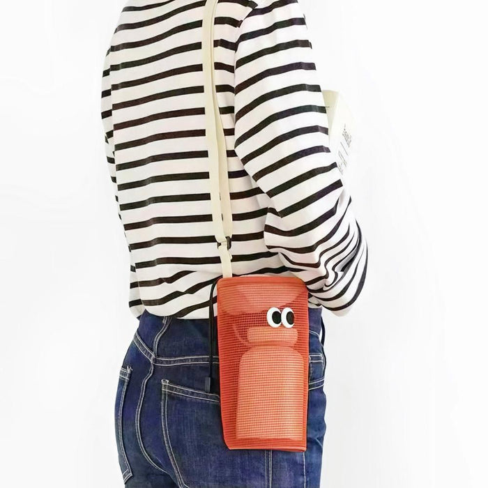 Model carrying a orange polyester crossbody bag , ideal for city walks and gifting.