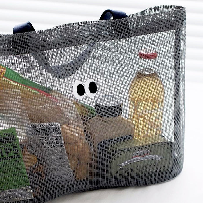 Flat lay of Googly Eyes Mesh Tote Bag in black, great for everyday carry and travel.