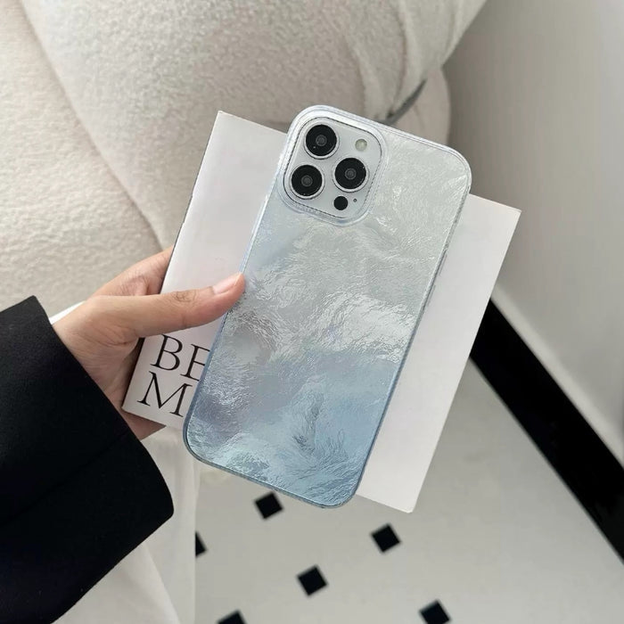 Model holding blue Gradient Glacier Case. Three-dimensional ice-like ripple texture for a unique grip.