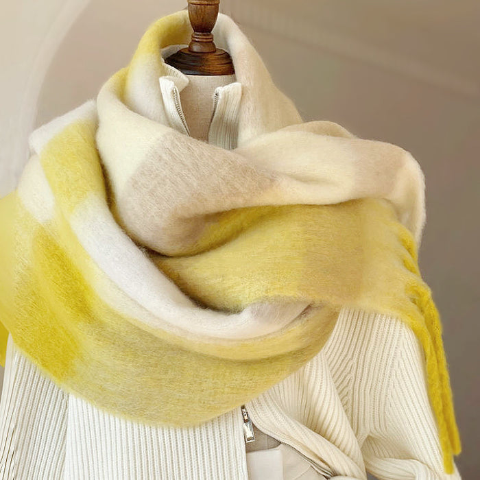 Model wearing the yellow and white gradient scarf over a white sweater , great for office layering.