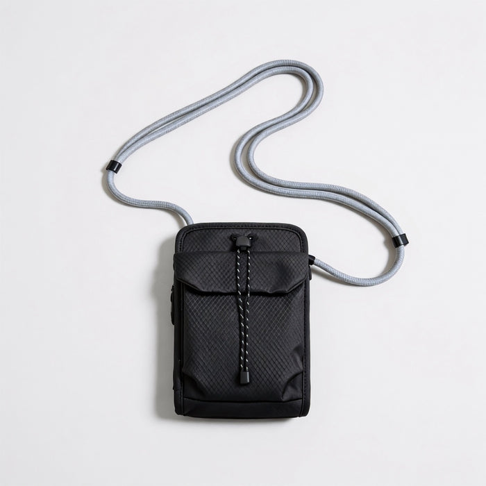 Front flat lay view of the classic black grid magnetic utility crossbody bag with adjustable rope strap.