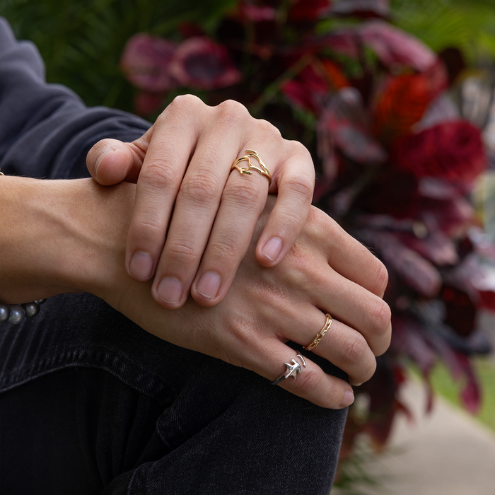 Man's hands on his lap wearing a Hammerhead Shark Ring in Sterling Silver