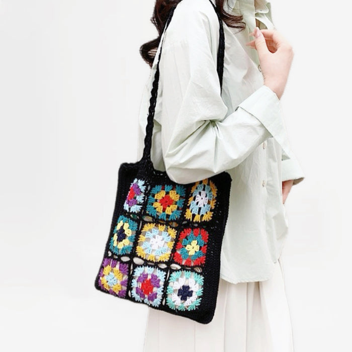 Model carrying a black floral shoulder bag, easy for commuting and weekends.