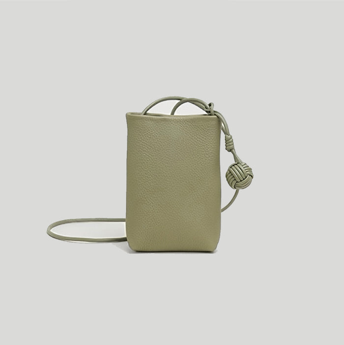 Flat lay of Hanging Ball Leather Bag in khaki green, great for everyday carry and travel.