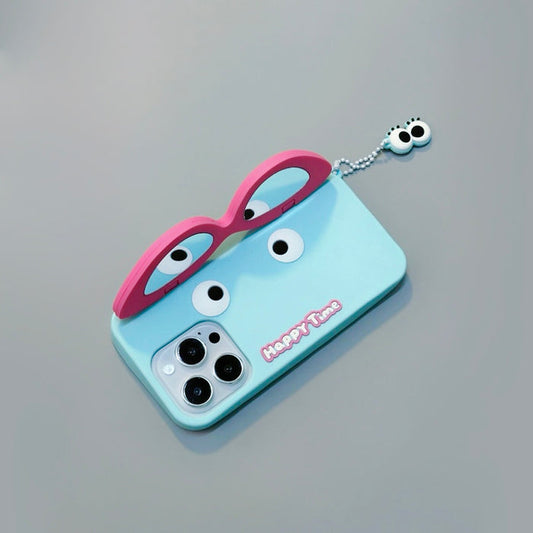 Light blue silicone iPhone case with pink glasses design and dangling eye charm. Eclectic joyful motifs.