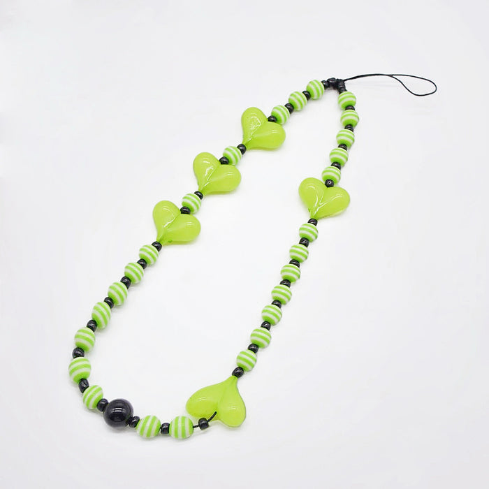 Angled view of Heart Beat Phone Charm with lime green hearts and striped bead.