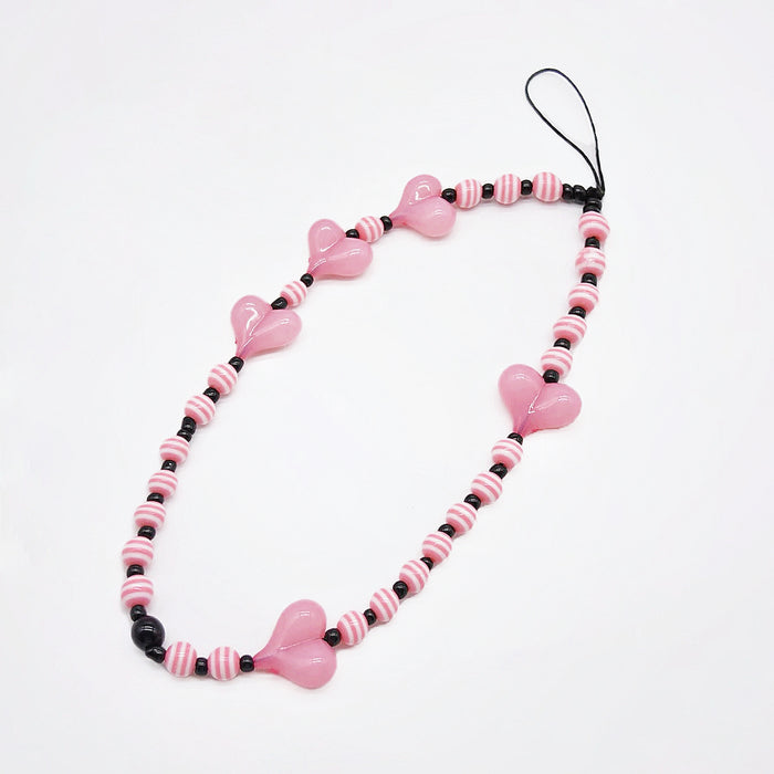 Close-up of Heart Beat Phone Charm with pink hearts and striped bead.