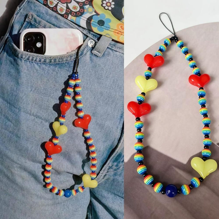 Close-up of Heart Beat Phone Charm in red, easy to attach to bags and phones.
