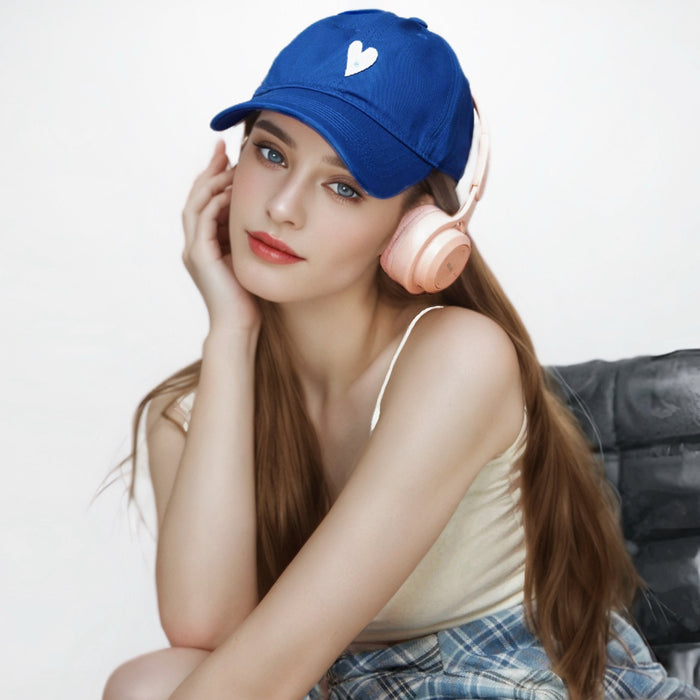 Klein blue cotton cap with white heart embroidery shown on a model.