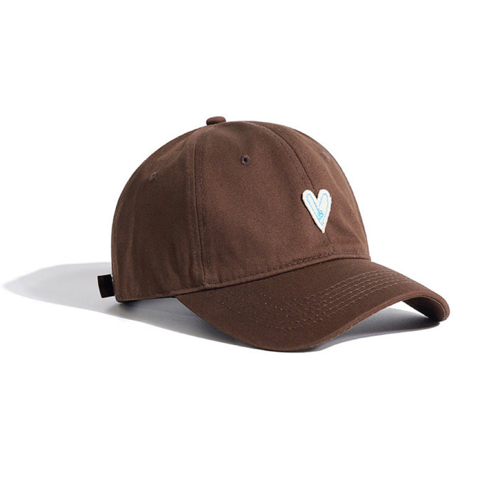 Side view of the brown heart embroidery cap showing the casual style.