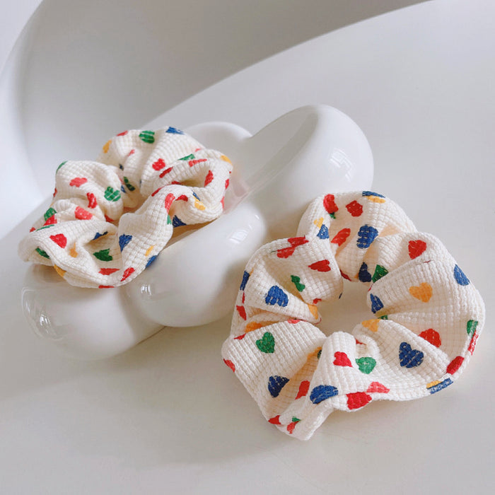 Close-up of two Heart Printed Scrunchie shown together, easy for workdays and special.