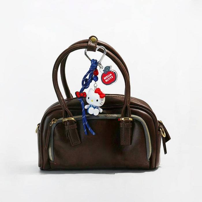 Hello Kitty Bag Charm hanging on a handbag, ideal for everyday outfits and street style.