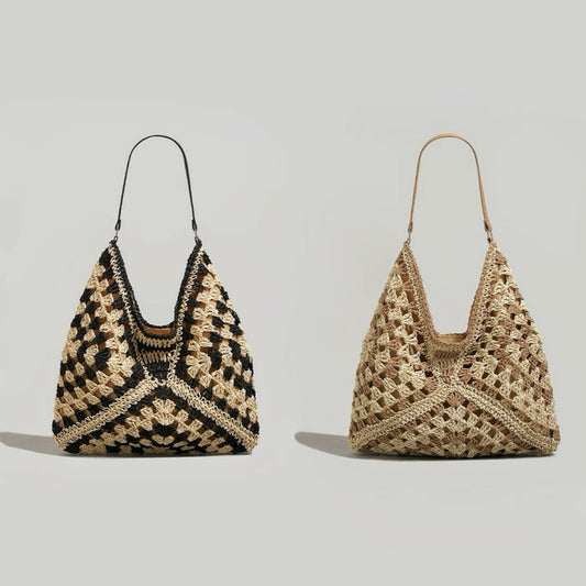 Two holiday style straw tote bags shown together. One is black and natural raffia, the other is all natural raffia.