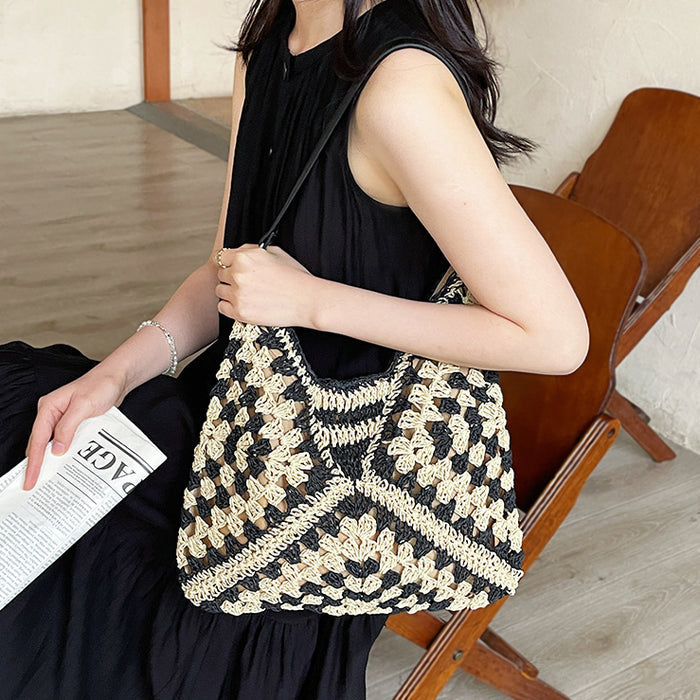 Model carrying a Holiday Style Straw Tote Bag in black, ideal for city walks and gifting.