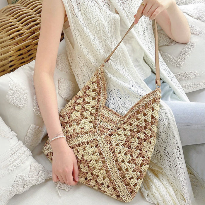 Model carrying a khaki  Holiday Style Straw Tote Bag, great for everyday carry and travel.